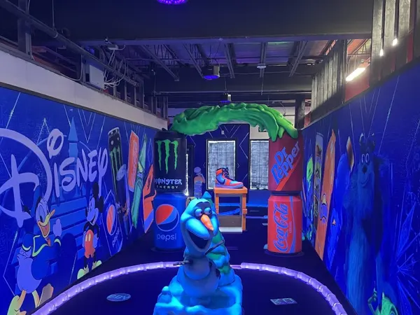 A glow-in-the-dark mini golf course lit in bright colors indoors at The Zone in Bluffton