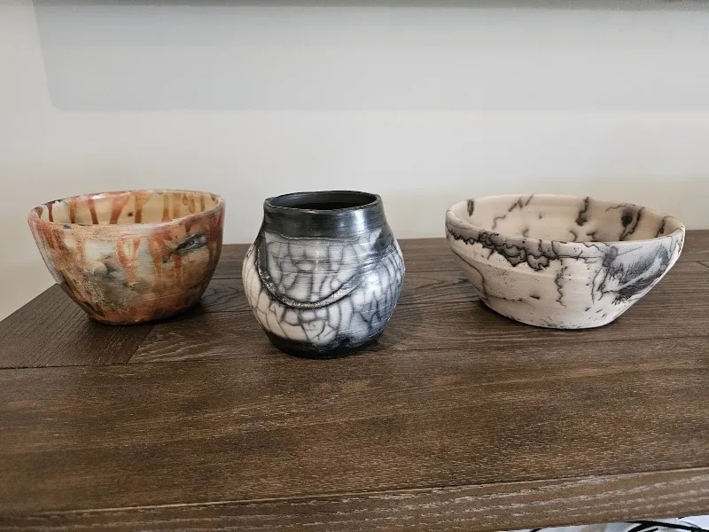 Three raku-fired pottery bowls with crackled glazes, made at Hilton Head Pottery